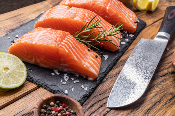 istock Fresh salmon fillets on black cutting board. 1473453619
