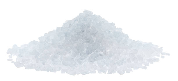 istock Pile of salt crystals on white background. File contains clipping path. 1473453624