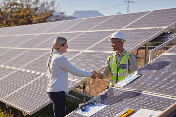 istock Woman, solar panel engineer and outdoor for handshake for agreement, inspection or sustainability at farm. Engineering black man, contractor and shaking hands for clean electricity, future or success 1473454409