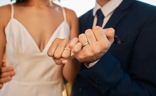 istock Love, wedding or hands of a couple promise trust, support or commitment in a romantic celebration event. Interracial marriage. Zoom, black woman and man together as bride and groom in a partnership 1473454671