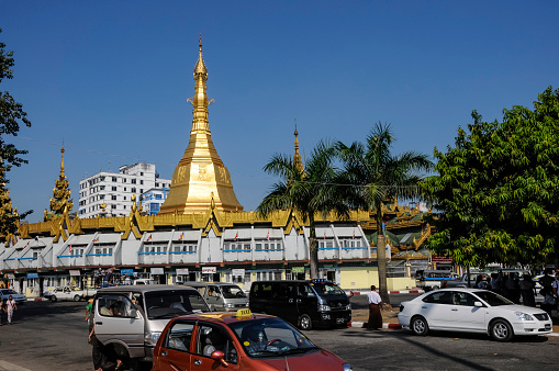 Yangon, Myanmar - oct 29, 2012 : view of the elegant stupa of Sule Pagoda in front of the skyscrapers of downtown Yangon