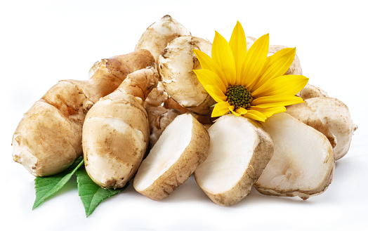 Jerusalem artichokes with flower and leaves isolated on white background.