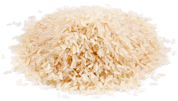 istock White rice. Heap of long raw rice isolated on white background. 1473456578