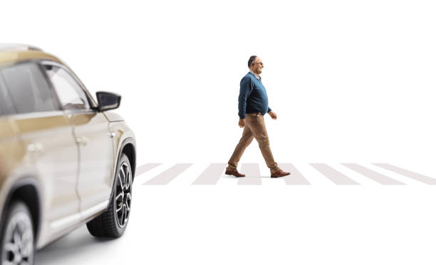 istock SUV waiting and a mature man walking on pedestrian crossing 1473457624
