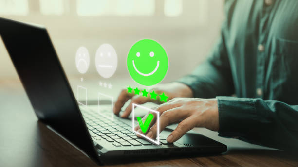 istock Man hand using computer laptop with popup five star icon for feedback review satisfaction service, testimonial. Customer service experience and business satisfaction survey. 1473457882