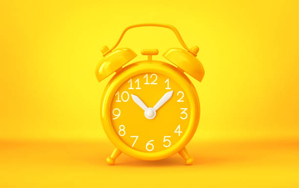 istock Yellow alarm clock on yellow background 1473459451