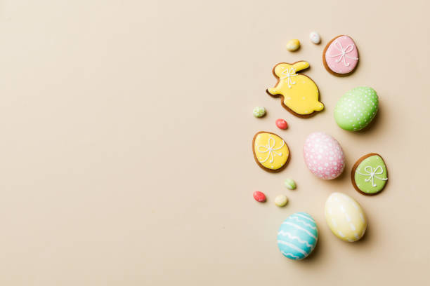 istock holiday preparation Multi colors Easter eggs with cookies on colored background . Pastel color Easter eggs. holiday concept with copy space 1473460827
