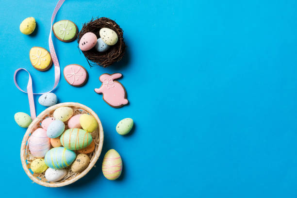 istock Colorful easter eggs in nest on table background with copy space top view 1473460839