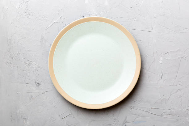 istock Top view of empty light plate on cement background. Empty space for your design 1473460895