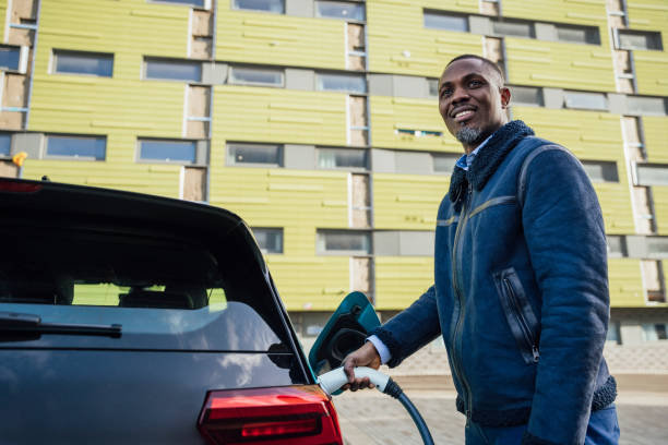 istock Businessman Charging Electric Car 1473461047