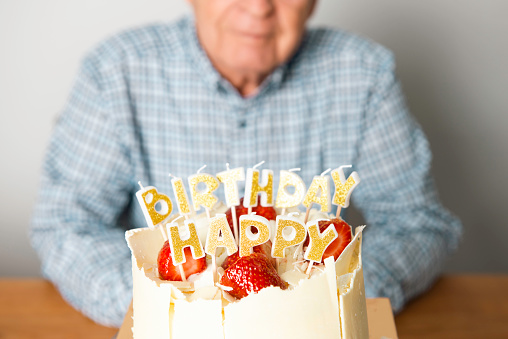 Senior man with birthday cake.