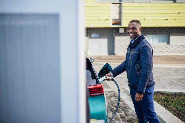 istock Businessman at Electric Car Charging Point 1473461880