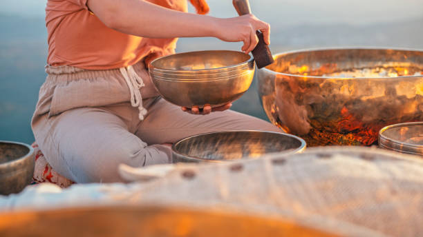 Close-up woman hands holding ring gong during sunset.