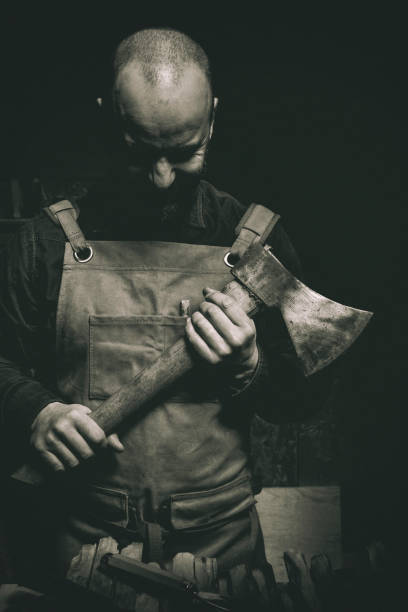 istock man with axe in hand and leather apron 1473463696