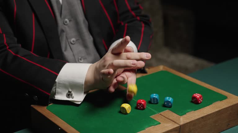 Close-up shot of a magician performing a trick with dice