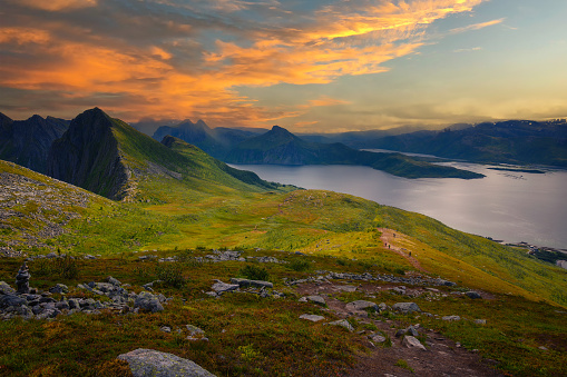 View from the Husfjellet Mountain on Senja Island in northern Norway at sunset over surrounding fjords and mountains.