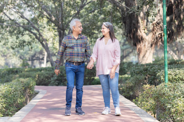 istock Happy senior couple spending leisure time in park 1473465763