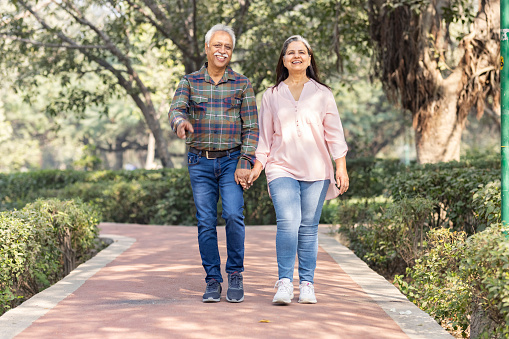 Happy senior couple spending leisure time in park during weekend