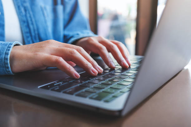 istock Closeup image of a woman working and typing on laptop computer keyboard 1473465854