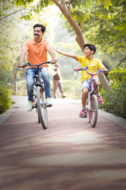 istock Young father and son having fun riding bicycle. 1473467724