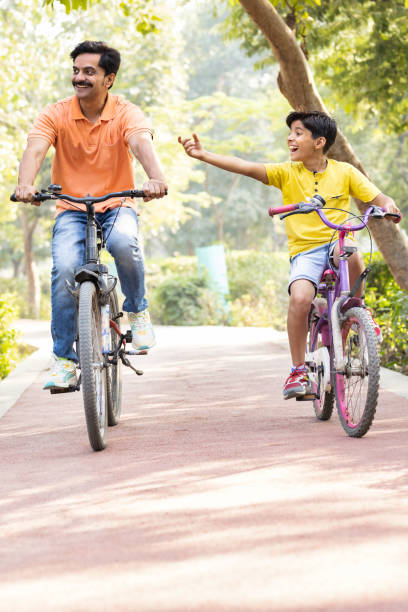 istock Young father and son having fun riding bicycle. 1473468320