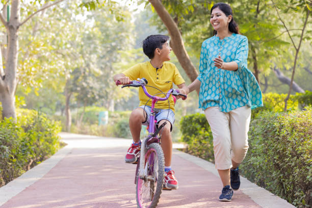 istock Mother teaching son to ride bicycle. 1473468364