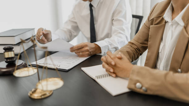 istock Counselor with legal documents discussing with client about legacy case. 1473469166