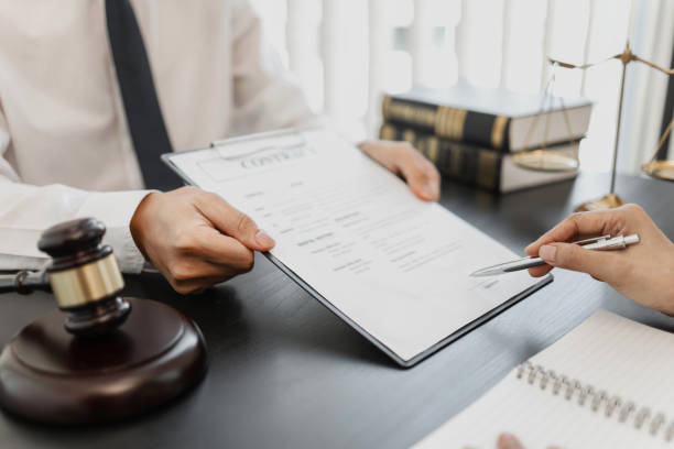 istock Counselor with legal documents discussing with client about legacy case. 1473469232