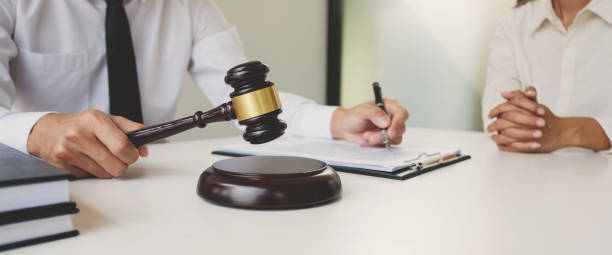 istock Counselor with legal documents discussing with client about legacy case. 1473469317