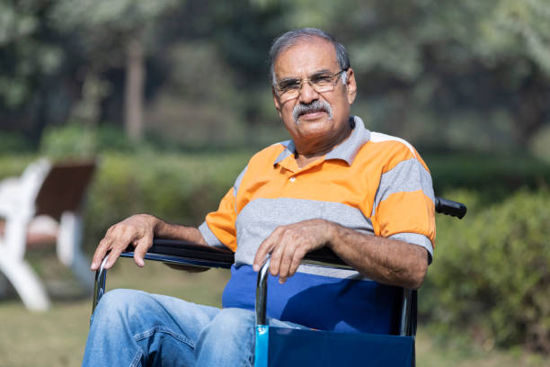 Senior man on wheelchair at park.