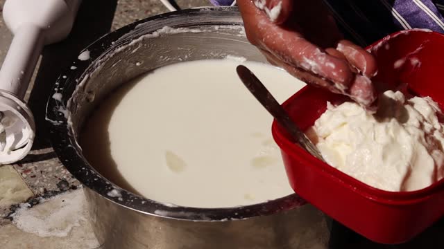 Closeup of Indian women hands making of Butter at home.