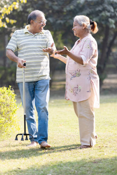 istock Laughing senior couple spending leisure time at park 1473471872