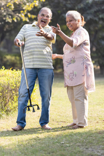 istock Laughing senior couple spending leisure time at park 1473471876