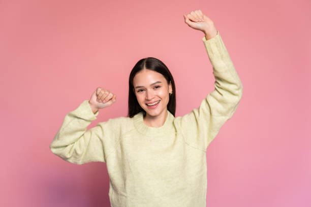 istock Smiling happy woman dancing and looking at camera 1473473370