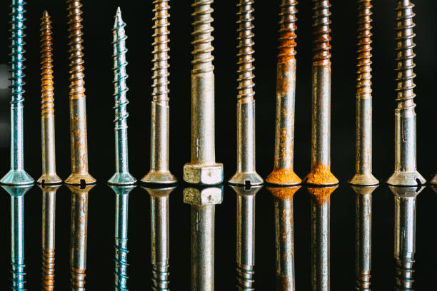 istock Screws in a row on black background 1473474559