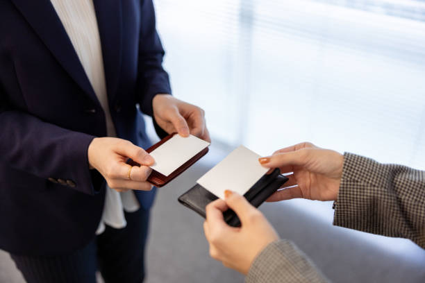 istock Business people changing business card 1473474946