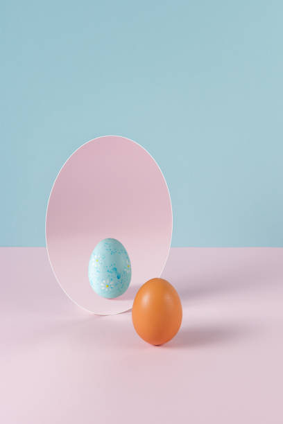 istock Creative Easter concept with egg and mirror on pastel pink and blue background. Minimal Easter holiday idea. 1473477167