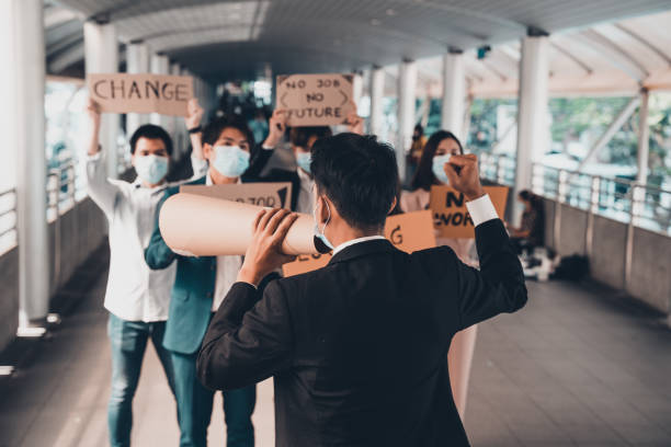 istock Group of activists with banners protesting to democracy and equality. Men and women doing a silent protest for democracy and equality 1473477598