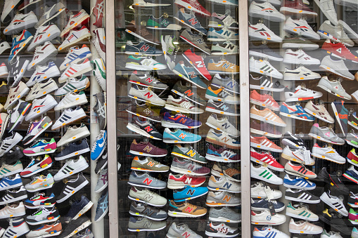 12th May 2022. Shop window in Rue Des Dames displaying dozens of training shoes. In recent years there has been growing concern about the environmental impact generated by the footwear industry, in particular by training shoe manufacturers.