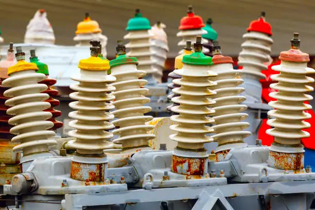 Photo of colored insulators on electrical towers close-up.