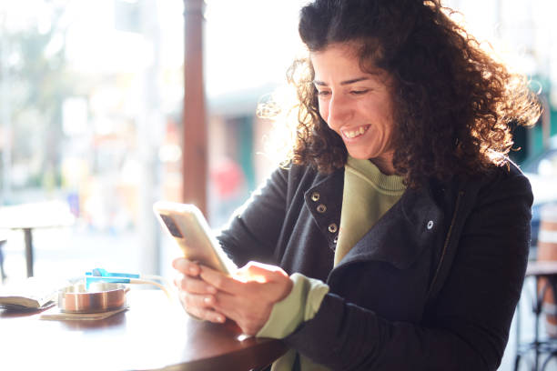 istock A woman is texting with friend in cafe 1473480358
