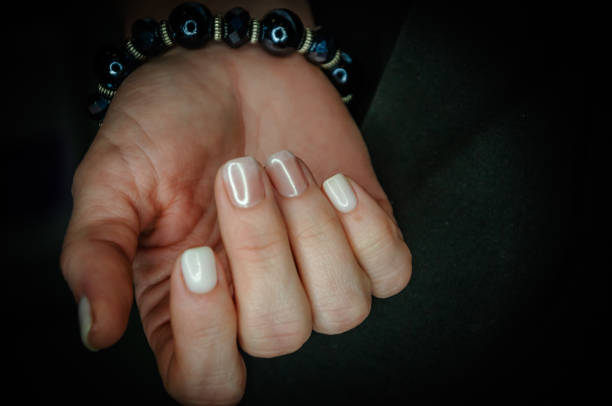 istock on a dark background light nails after manicure 1473480438