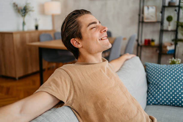 istock Young Man Relaxing On The Sofa At Home 1473483578
