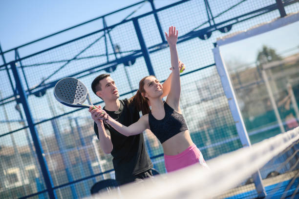 istock Young people playing Padel Tennis, Trainer teaching 1473483703