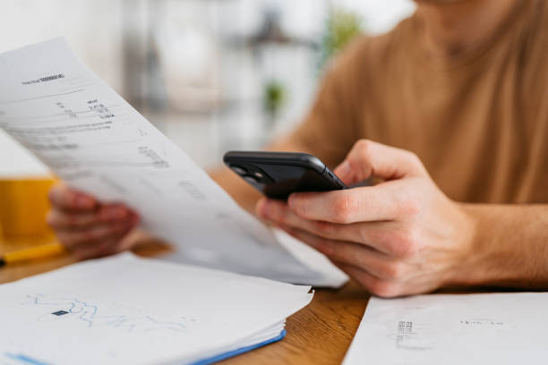 istock Young Man Checking His Finances At Home 1473484484