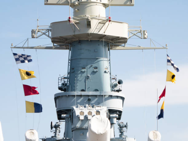 Battleship USS North Carolina docked at Wilmington, NC, showing colorful battle flags  blowing in the wind. stock photo