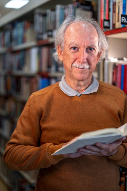 istock Caucasian Man Slightly Smiling At The Camera At The Library 1473485211