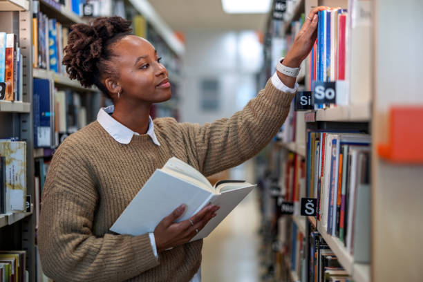istock Young African-American Student Trying to Find A Book 1473485214