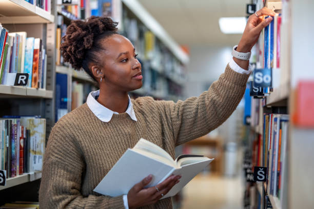 istock Young African-American Student Trying to Find A Book 1473485219