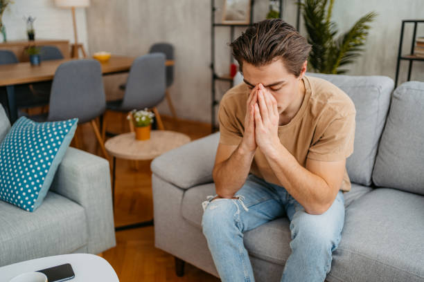 istock Sad Young Man Sitting At Home On The Sofa 1473485240